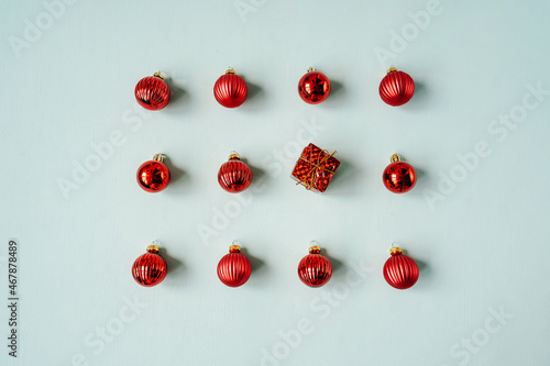 Red Christmas baubles decoration on blue background.