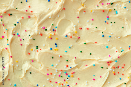 Cake frosting texture background vector with sprinkles on top photo