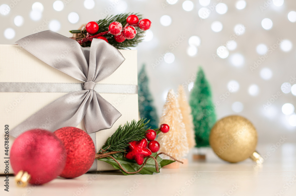 Christmas background with trees, gifts and Christmas balls. Christmas decor on bokeh lights background, copy space