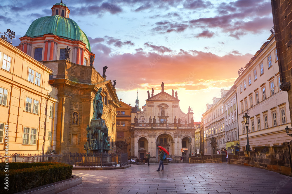 Prague, Czech Republic. Sunset at Square of Knights of the Cross. Church of Saint Francis of Assisi and Saint Salvator Cathedral. Old town street with medieval architecture.