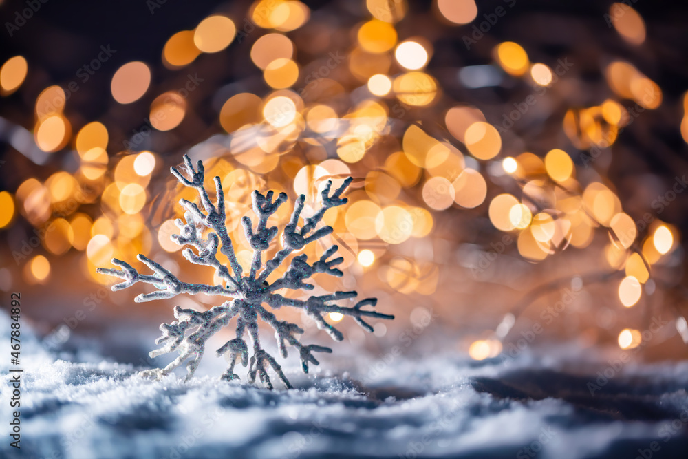 Christmas glass ball with snowflake ornament on snow