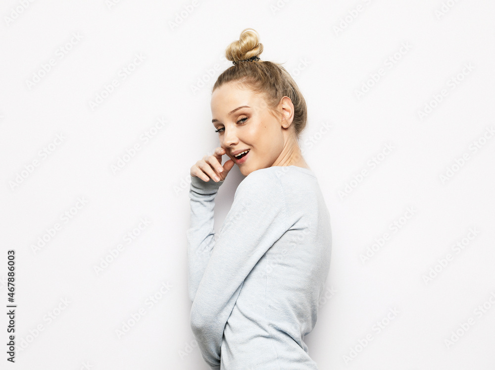 Portrait of young blonde positive female with cheerful expression, dressed in casual clothes, over white background. Portrait of young blonde positive female with cheerful expression, dressed in casual clothes, over white background.