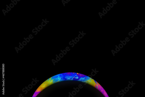 Abstract multicolor psychedelic planet in universe. Closeup soap bubble like an alien planet on dark background
