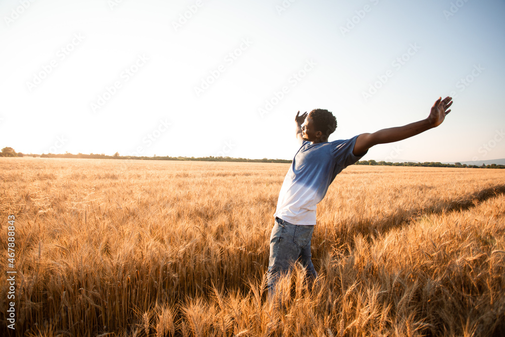 Unspecified man with hands up watching sunset