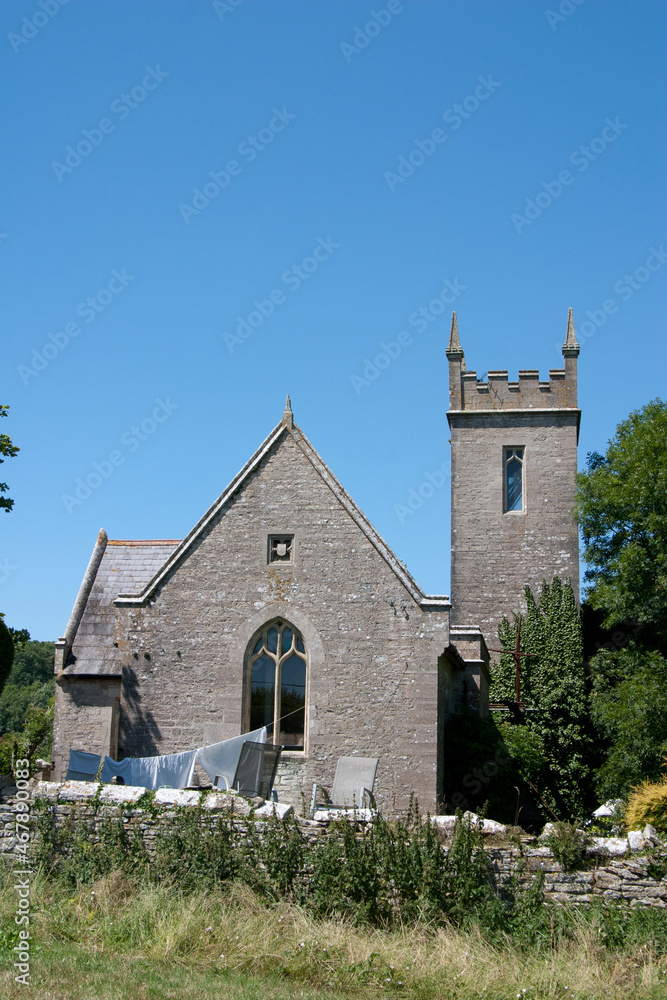 A converted church now used as a house with a washing line in the garden