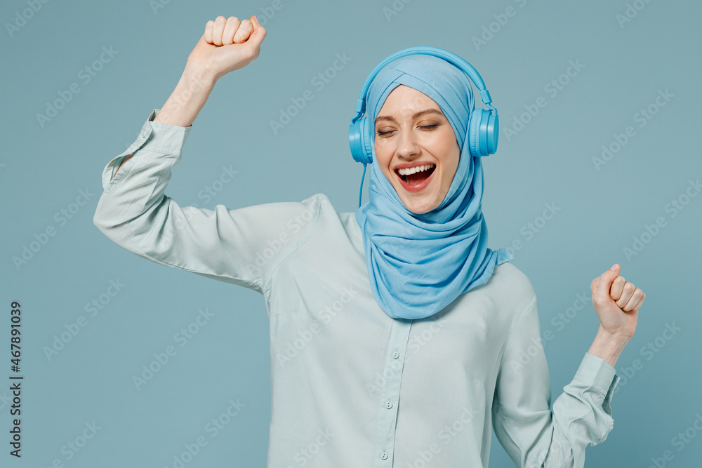 Young smiling arabian asian muslim woman in abaya hijab headphones ...
