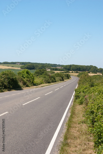 An empty straight road vanishing into the distance through attractive countries