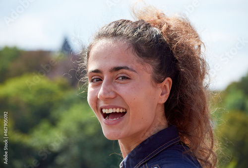 A portrait of a cheerful young Caucasian female smiling