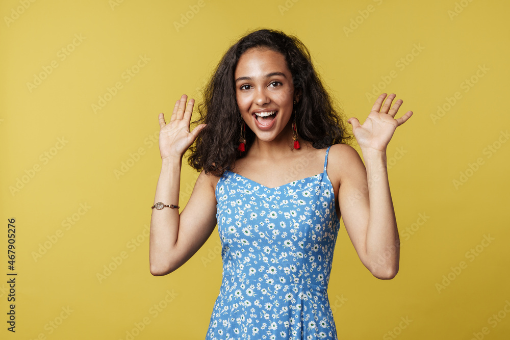 Young hispanic woman smiling and showing her palms at camera