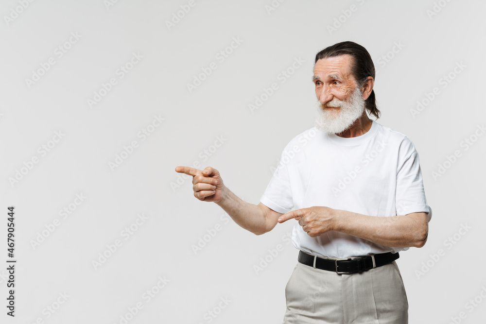European senior man pointing finger and looking aside European senior man pointing finger and looking aside