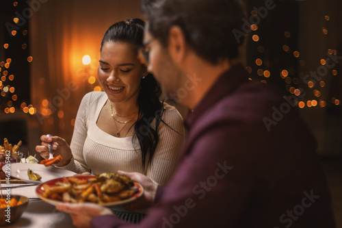 holidays  party and celebration concept - happy friends having christmas dinner at home