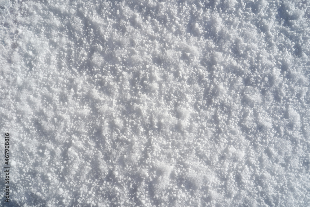 Fine fresh snow pattern texture background on a sunny day from directly above. Fine fresh snow pattern texture background on a sunny day from directly above.
