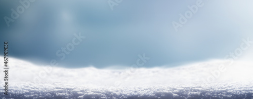 A cold winter snow landscape with cold blue background for a traditional Christmas scene. © Duncan Andison