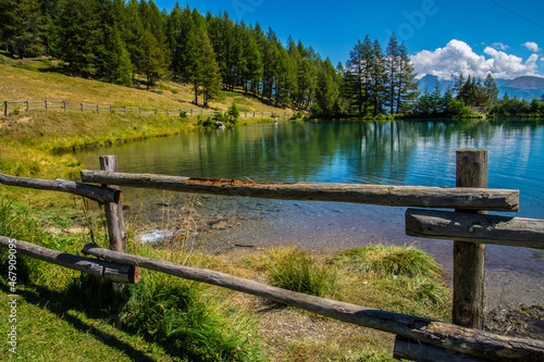 Wooden fence surrounding the Lake of Joux in Vens, Val Aoste, Italy photo