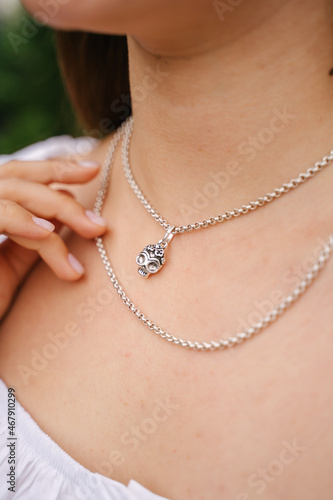 Close-up of a female jewelry on a girl's neck, a beautiful silver necklace