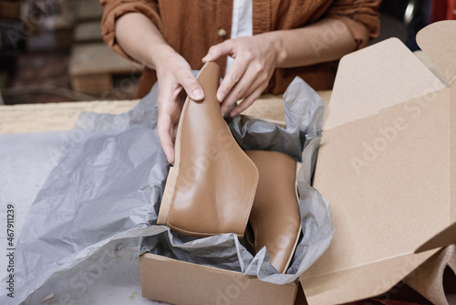 Close-up of woman packing new pair of shoes into box for delivering © AnnaStills