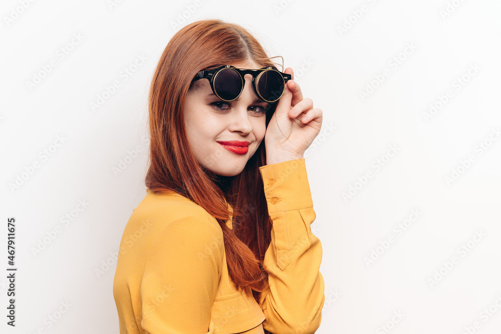 Naklejka premium glamorous woman sunglasses red hair light background