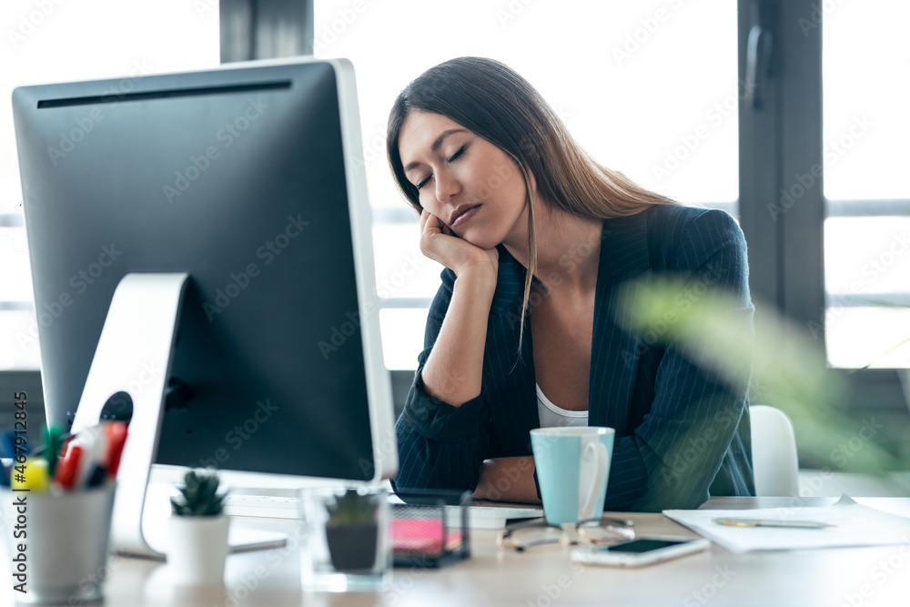 Shot of elegant business woman sleeping while working with computer in the office. Shot of elegant business woman sleeping while working with computer in the office.