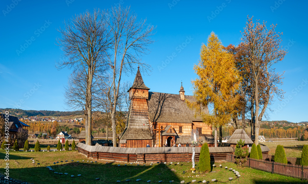 Old medieval Gothic wooden church of the Saint Archangel Michael in Debno, Poland. Autumn panorama. UNESCO World Heritage Site. Aerial panorama.
