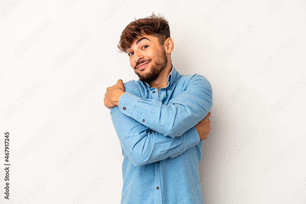 Young mixed race man isolated on grey background hugs, smiling carefree and happy. Young mixed race man isolated on grey background hugs, smiling carefree and happy.