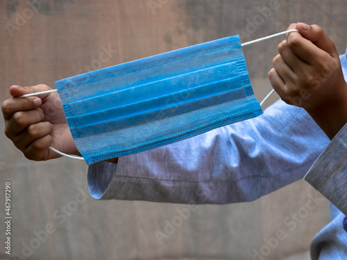 Wallpaper Mural Little girl children shows how to wear a mask during pandemic. Infection control concept. Torontodigital.ca