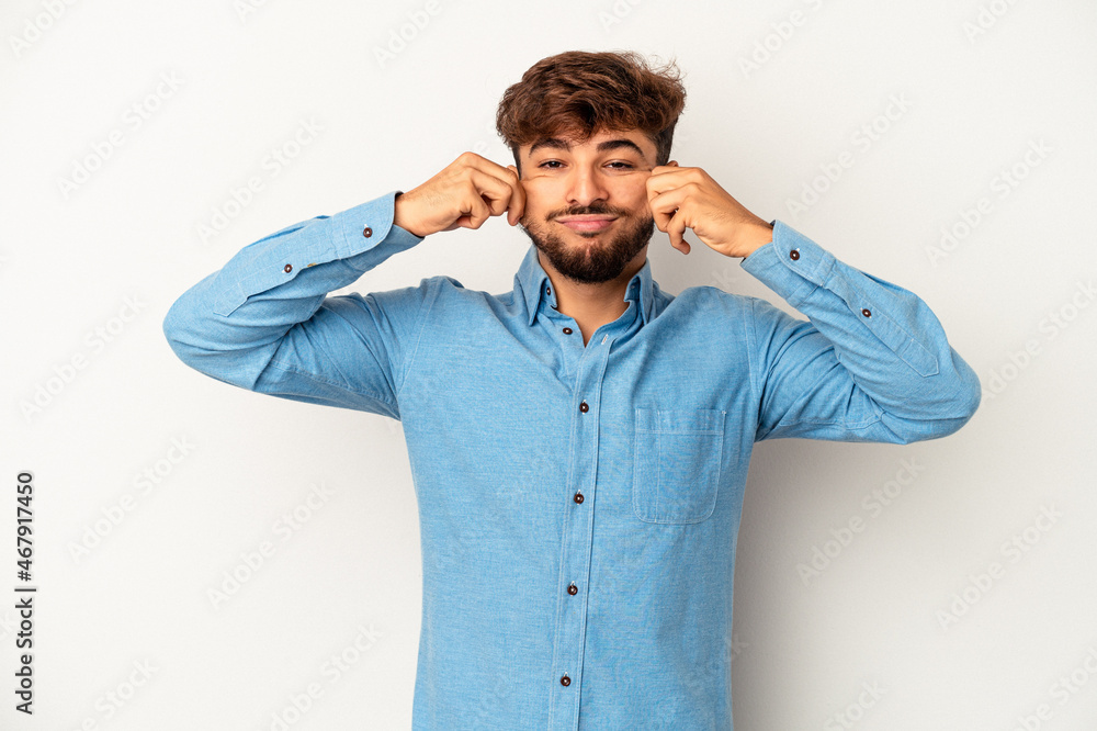 Young mixed race man isolated on grey background doubting between two options. Young mixed race man isolated on grey background doubting between two options.