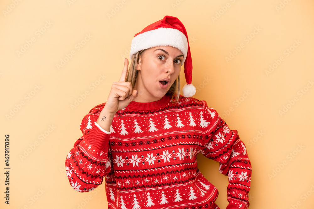 Young caucasian woman celebrating Christmas isolated on yellow background having an idea, inspiration concept. Young caucasian woman celebrating Christmas isolated on yellow background having an idea, inspiration concept.