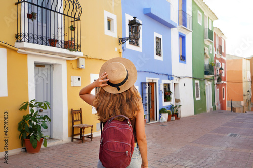 Holidays in Europe. Happy tourist girl visiting the colorful Spanish village Villajoyosa, Alicante, Spain. photo
