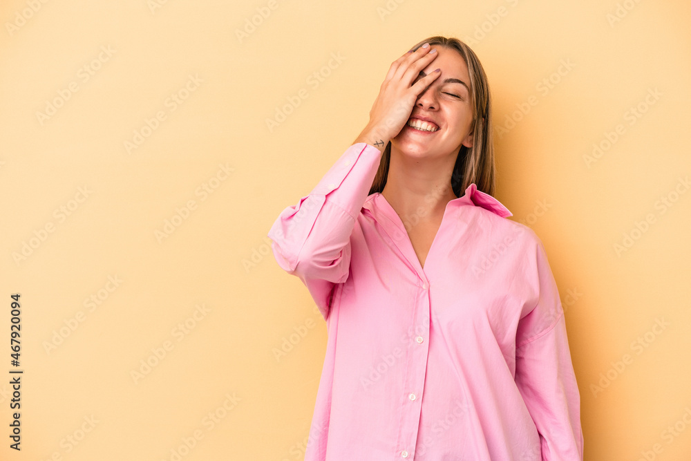 Young caucasian woman isolated on yellow background laughing happy, carefree, natural emotion. Young caucasian woman isolated on yellow background laughing happy, carefree, natural emotion.