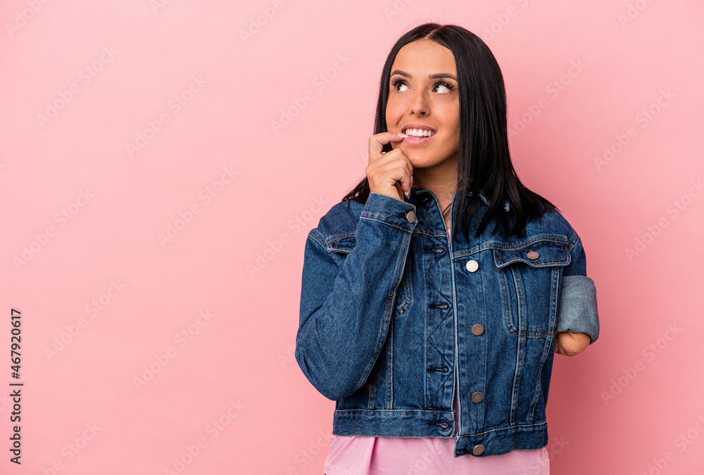 Young caucasian woman with one arm isolated on pink background relaxed thinking about something looking at a copy space. Young caucasian woman with one arm isolated on pink background relaxed thinking about something looking at a copy space.