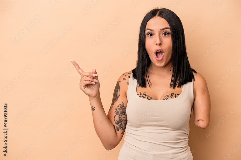 Young caucasian woman with one arm isolated on beige background pointing to the side Young caucasian woman with one arm isolated on beige background pointing to the side