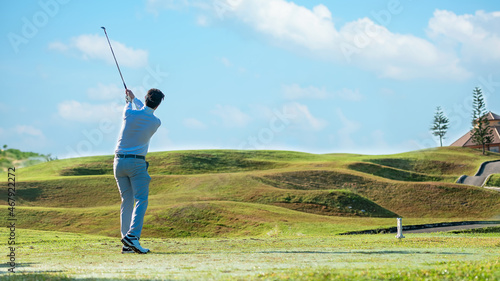 Golfer sport course golf ball fairway.  People lifestyle man playing game and swing golf tee off on the green grass.  Asian man player game shot in summer.  Healthy and Sport outdoor