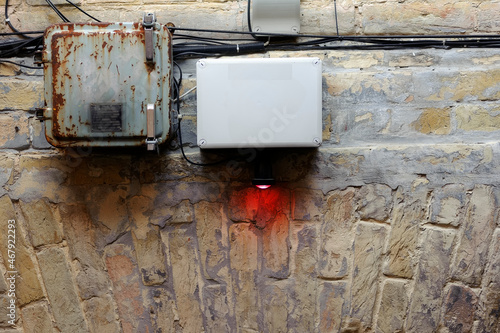 Technical devices and red lamp on the wall