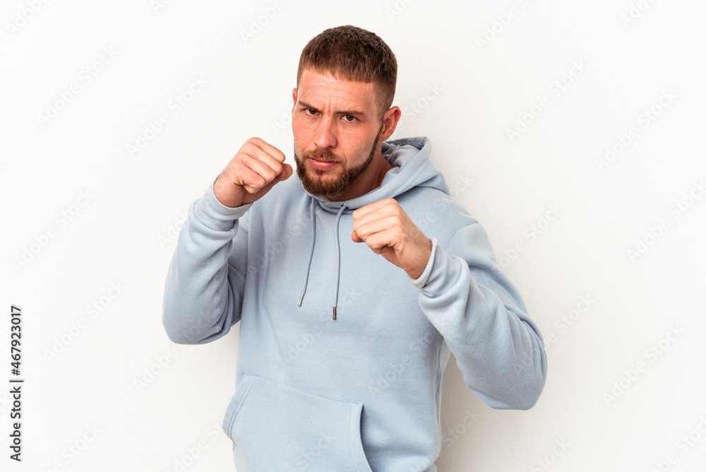 Young caucasian man with diastema isolated on white background throwing a punch, anger, fighting due to an argument, boxing. Young caucasian man with diastema isolated on white background throwing a punch, anger, fighting due to an argument, boxing.
