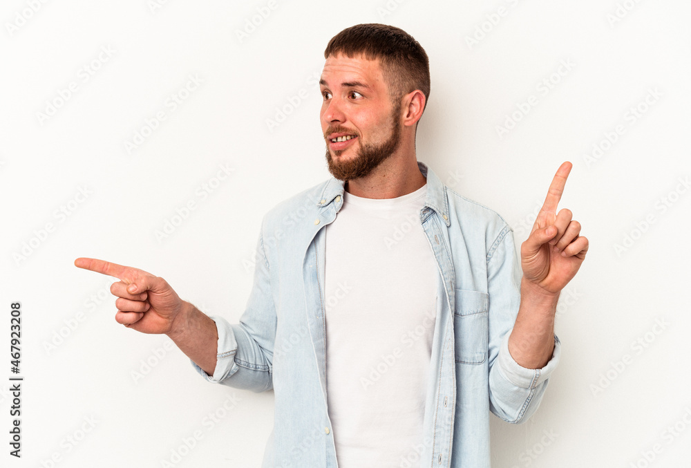 Young caucasian man with diastema isolated on white background pointing to different copy spaces, choosing one of them, showing with finger. Young caucasian man with diastema isolated on white background pointing to different copy spaces, choosing one of them, showing with finger.