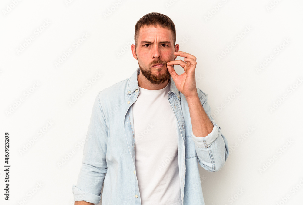 Young caucasian man with diastema isolated on white background with fingers on lips keeping a secret. Young caucasian man with diastema isolated on white background with fingers on lips keeping a secret.