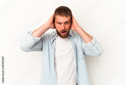 Young caucasian man with diastema isolated on white background screaming, very excited, passionate, satisfied with something.