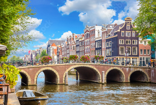Obraz na płótnie Amsterdam downtown - Amstel river, old houses and a bridge. Nice view of the famous city of Amsterdam. Travel to Europe. w salonie