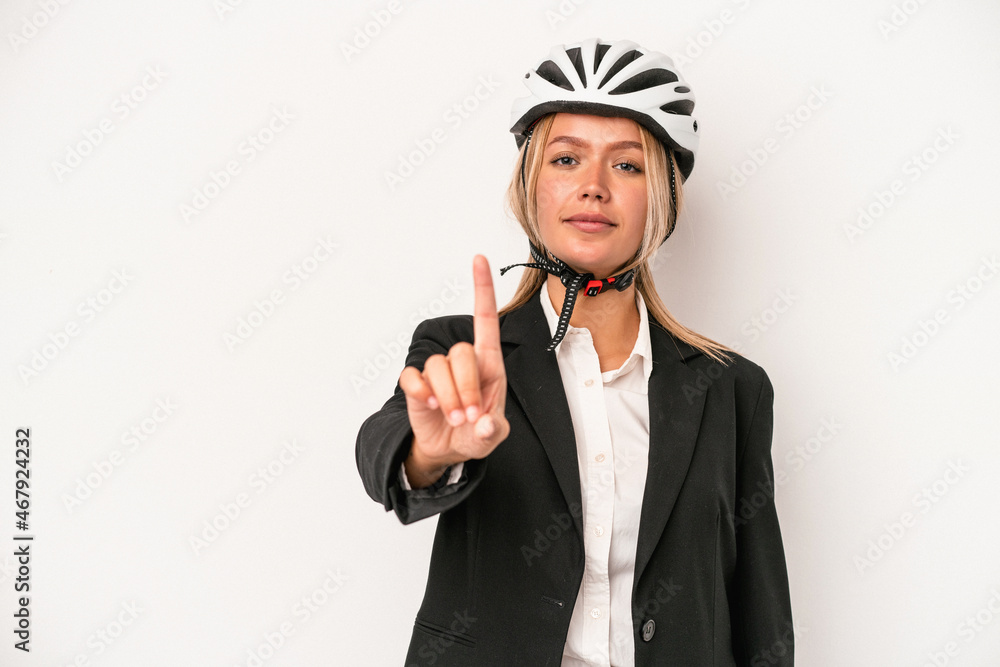 Young caucasian business woman wearing a bike helmet isolated on white background showing number one with finger. Young caucasian business woman wearing a bike helmet isolated on white background showing number one with finger.