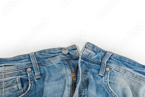 Blue jeans button isolated on the white background, folded, trendy, stylish, fashionable denim.