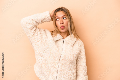 Young caucasian woman isolated on beige background being shocked, she has remembered important meeting. © Asier