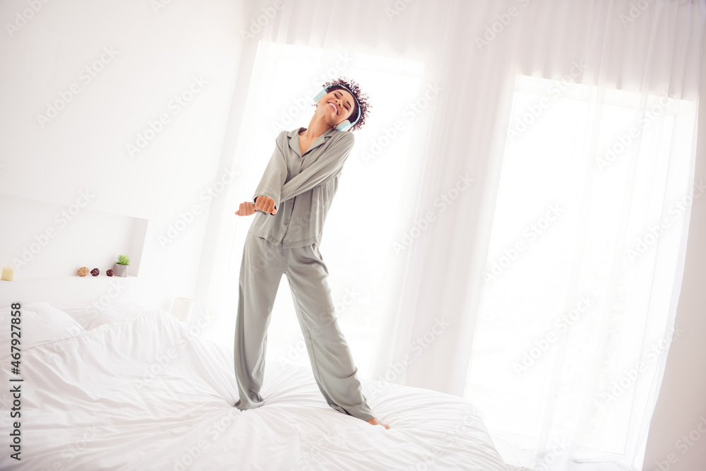 Photo of funky inspired lady stay bed dance enjoy favorite track wear earphones silky gown in light bedroom home indoors Photo of funky inspired lady stay bed dance enjoy favorite track wear earphones silky gown in light bedroom home indoors