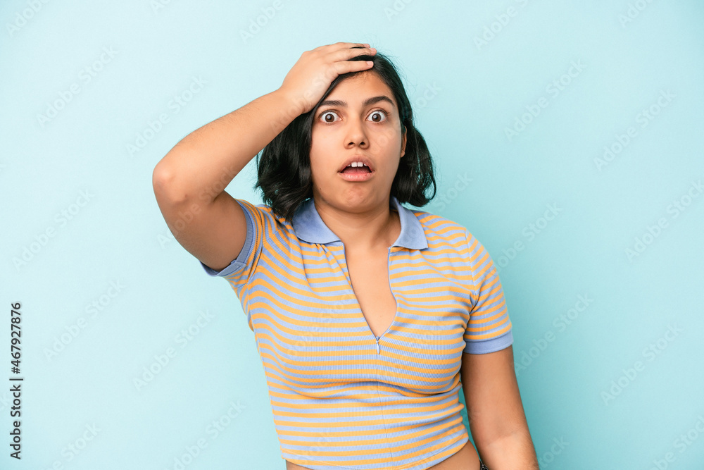 Young latin woman isolated on blue background being shocked, she has remembered important meeting.