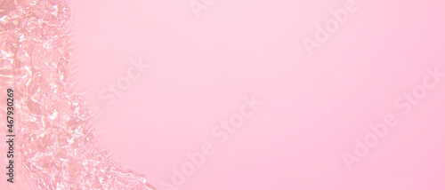 Transparent pink clear water surface texture with ripples, splashes and bubbles. Abstract summer banner background Water waves in sunlight with copy space Cosmetic moisturizer micellar toner emulsion © Aleksandra Konoplya