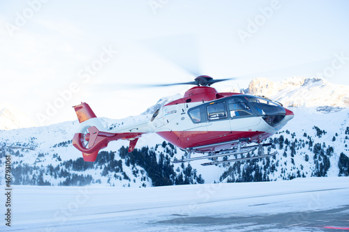 Rescue helicopter lands in the Alps photo