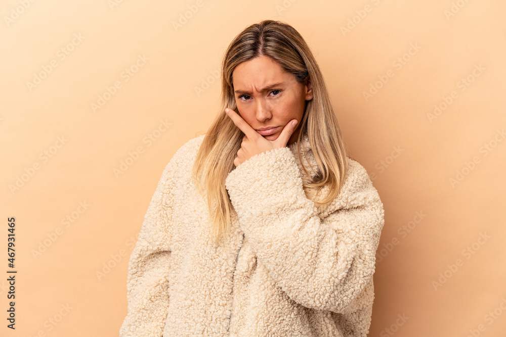 Young caucasian woman isolated on beige background contemplating, planning a strategy, thinking about the way of a business. Young caucasian woman isolated on beige background contemplating, planning a strategy, thinking about the way of a business.