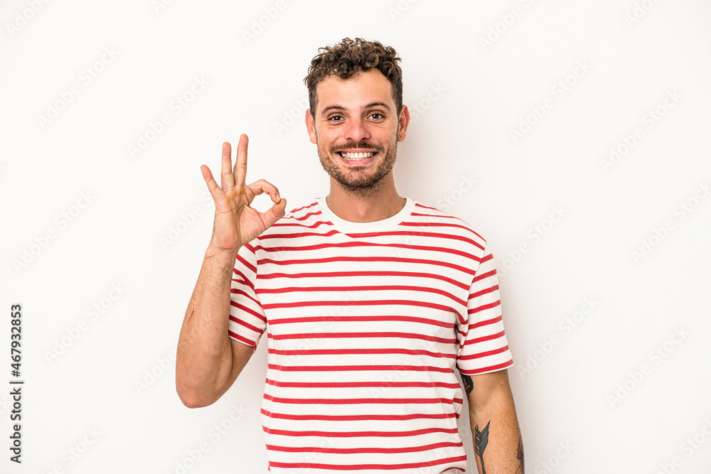 Fototapeta premium Young caucasian man isolated on white background cheerful and confident showing ok gesture.