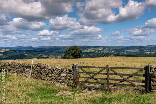 landscape with fence and blue skies and clouds  farming scene in the UK