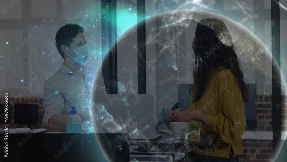 Animation of glowing global communication network over man and woman in face masks talking in office Animation of glowing global communication network over man and woman in face masks talking in office