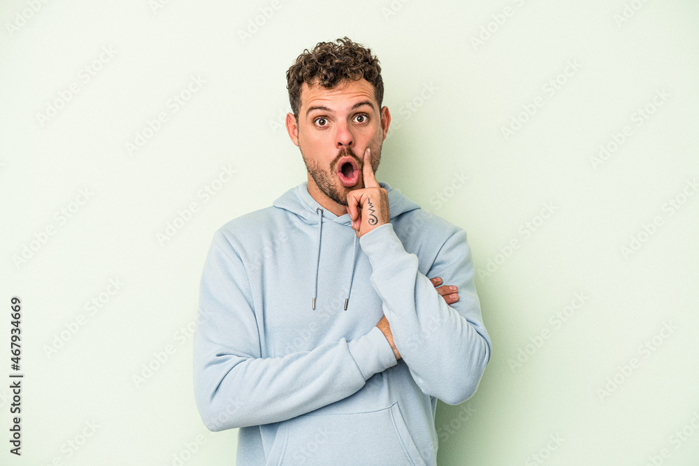 Young caucasian man isolated on green background having some great idea, concept of creativity. Young caucasian man isolated on green background having some great idea, concept of creativity.